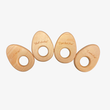 Four wooden egg holder rings with humorous inscriptions on a white background