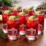 Set of 6 boat etched design glasses filled with red beverage, lemon slices, and rosemary sprigs on a wooden surface.