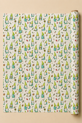 A roll of wrapping paper with a repeating pattern of cute green and blue gnomes on a cream background, displayed flat with the roll standing on the right side against a warm beige backdrop.