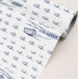 Roll of paper with blue boat pattern on a white background