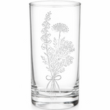Clear glass tumbler with floral engraving on a white background