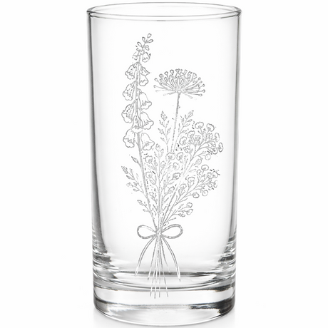 Clear glass tumbler with floral engraving on a white background