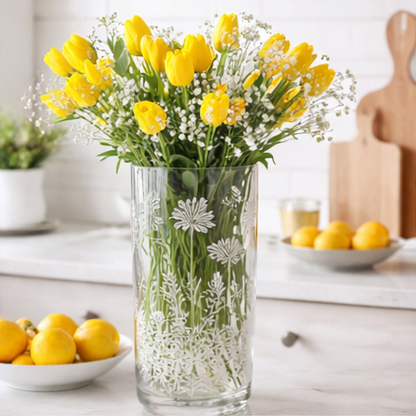 Four different floral arrangements in clear vases on various surfaces.