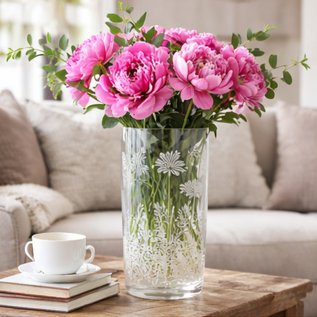 floral arrangement in clear vases with floral engraving on wood table