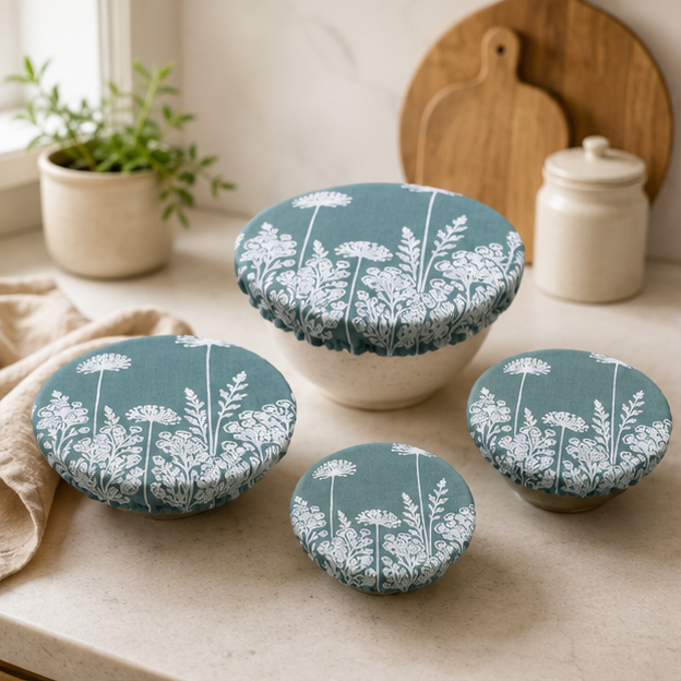 A set of three reusable Duck Egg Green Florilegium linen bowl covers, hand printed in Derbyshire with a delicate white botanical design featuring agapanthus and foxglove flowers.