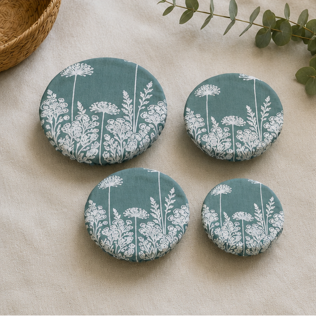 A set of three reusable Duck Egg Green Florilegium linen bowl covers, hand printed in Derbyshire with a delicate white botanical design featuring agapanthus and foxglove flowers.
