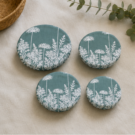 A set of three reusable Duck Egg Green Florilegium linen bowl covers, hand printed in Derbyshire with a delicate white botanical design featuring agapanthus and foxglove flowers.