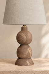 Smooth farmhouse brown finish and visible grain on the hand-carved Frampton lamp base