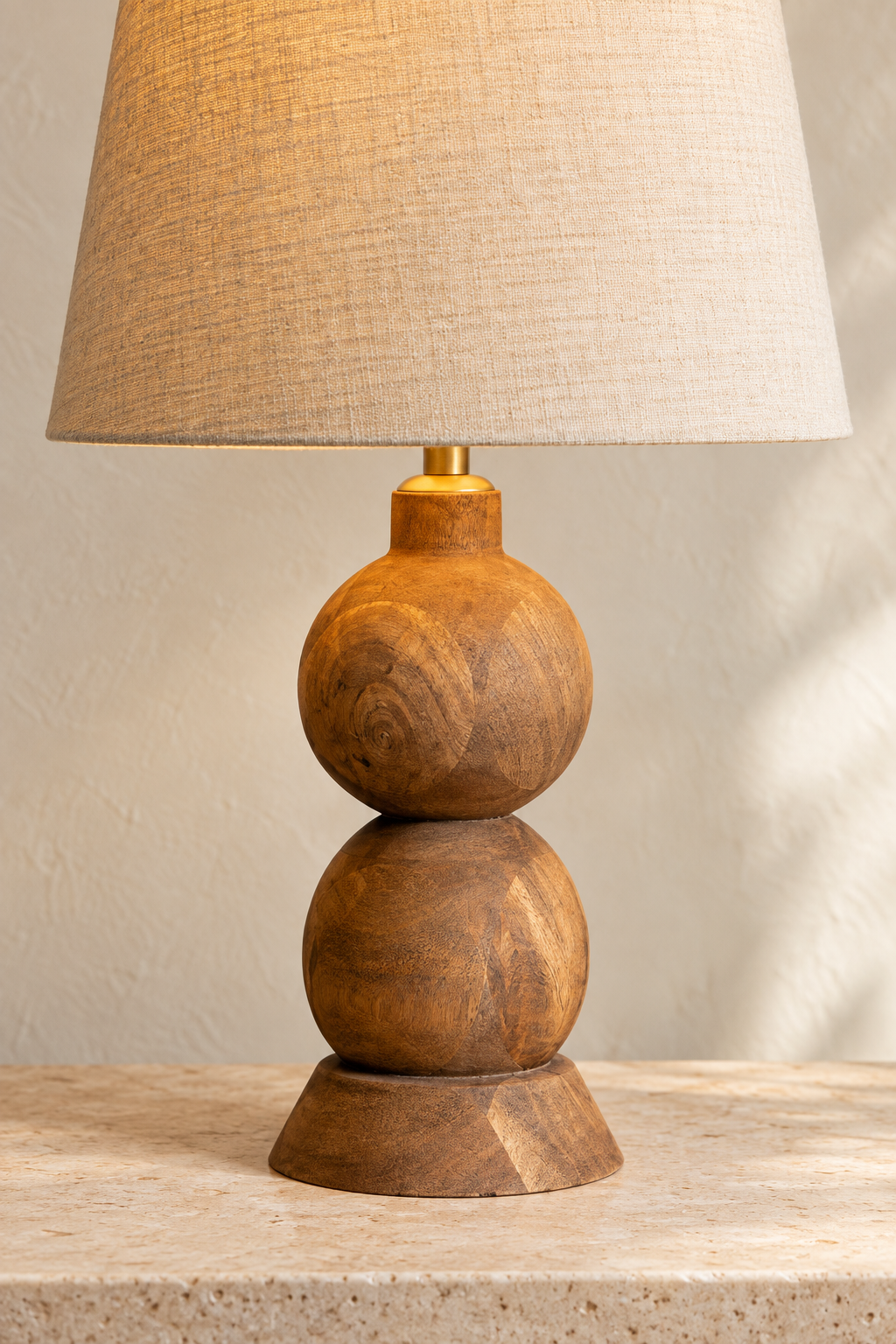 Frampton Medium mango wood table lamp with a rounded brown base and tapered beige linen shade