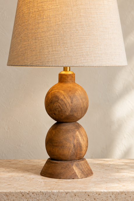 Frampton Medium mango wood table lamp with a rounded brown base and tapered beige linen shade
