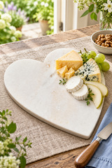 Heart-shaped cheese board made from natural white marble, for presenting cheese and accompaniments. Measures 23cm wide × 27cm long × 1.5cm thick.