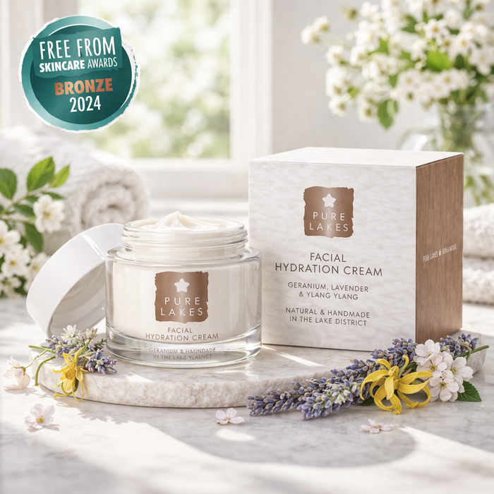 Pure Lakes facial hydration cream jar and box on a marble surface with flowers and 'Free from Skincare Awards Bronze 2024' badge.