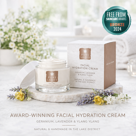 Facial hydration cream with packaging on a marble surface with flowers, featuring an award badge.