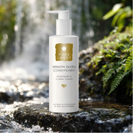 Geranium & Ylang Ylang Keratin Silken Conditioner on rock with plants and running water