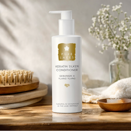 Geranium & Ylang Ylang Keratin Silken Conditioner on wooden bathroom side