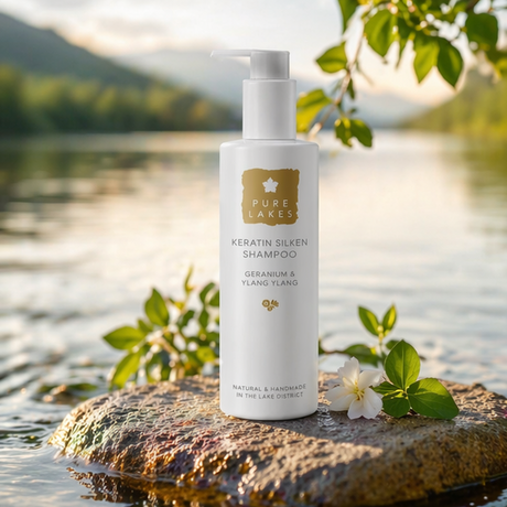 Shampoo bottle labeled 'Pure Lakes' on a rock by a lake with mountains in the background