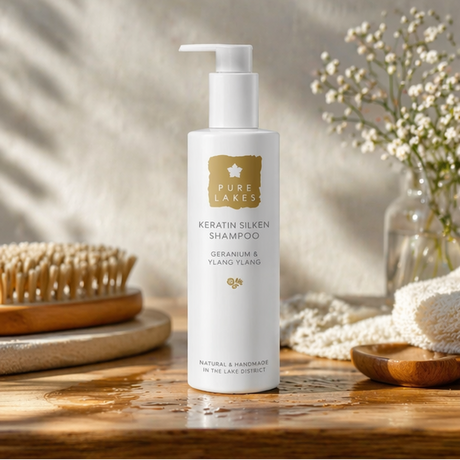 Pure Lakes Keratin Silken Shampoo bottle on a wooden surface with a blurred background