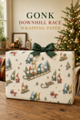 Gonk Christmas wrapping paper showing six colourful bearded gonks racing downhill on a wooden sledge with snowy trees, stars, mittens and smaller winter scenes.