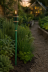 Green 60cm Bamboo Garden Fire Torch with Oil Chamber, lit on the side of a garden path.