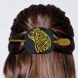 Hair bun with a decorative hair clip featuring a tiger design on a white background