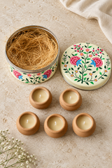 Gift set containing five hand-poured candles in terracotta pots and one reusable white hand-painted stainless steel tin. Candles are handmade by members of the Dalit community in India and scented with lavender and a subtle hint of vanilla