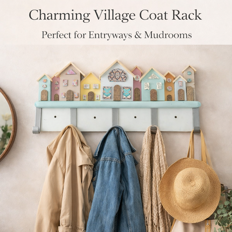 Decorative coat rack with pastel-colored houses and hanging clothes on a beige wall.