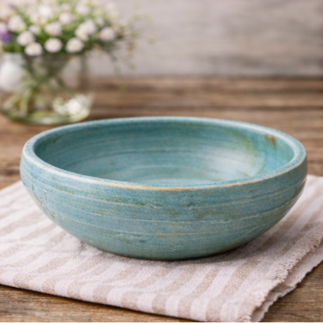 Handcrafted ceramic bowl on a wooden surface 