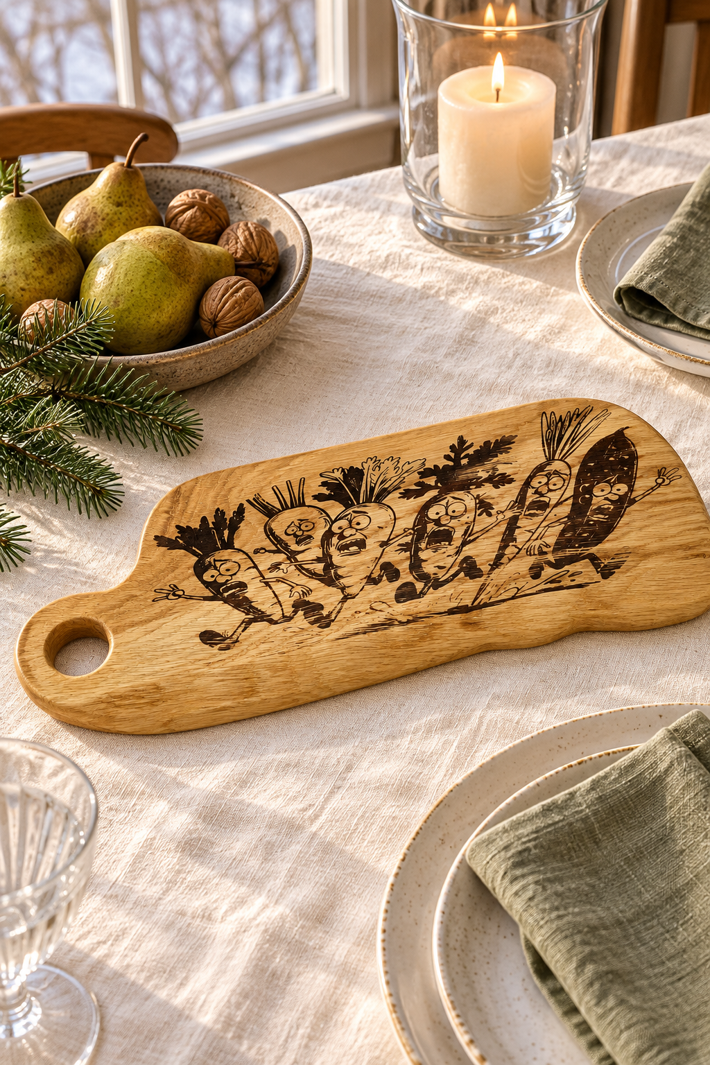 A wooden serving board with a engraved design of vegetable caricatures, styled on a dining table with a candle, pears, and plates.