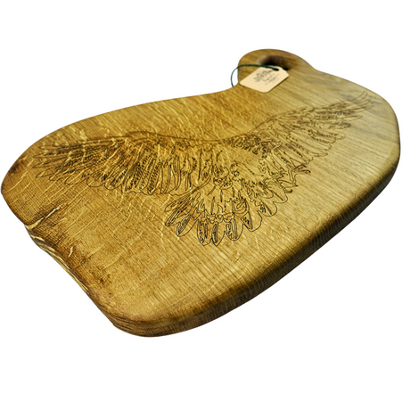 Wooden cutting board with engraved eagle design on a white background