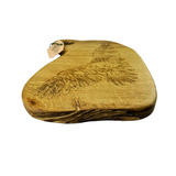 Wooden cutting board with engraved design on a white background