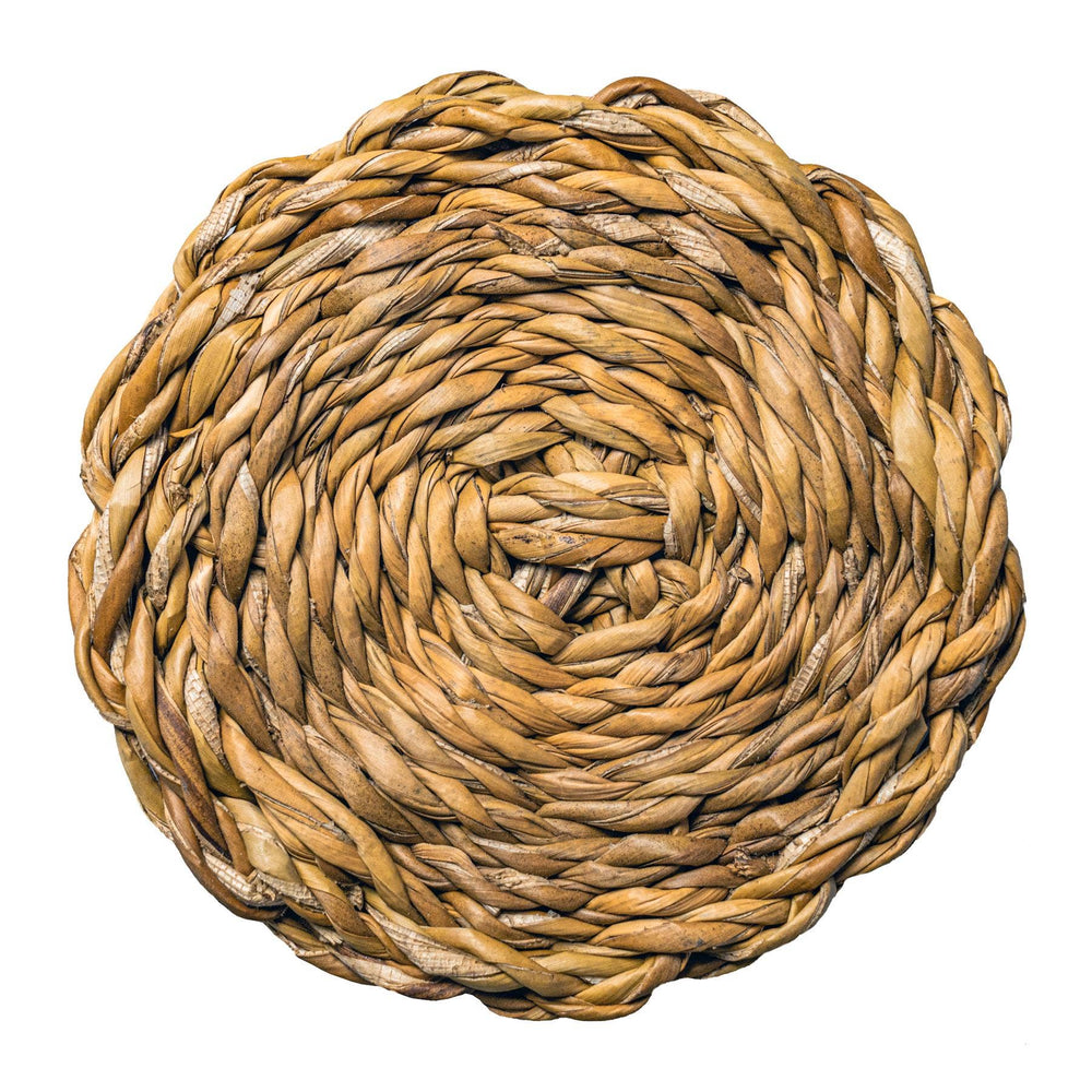Round woven mat made of natural fibers on a white background