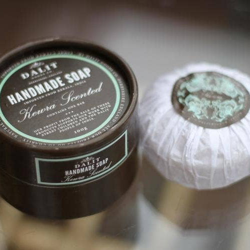 Handmade soap with a container labeled 'DALIT' on a blurred background