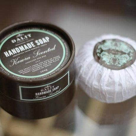 Handmade soap with a container labeled 'DALIT' on a blurred background
