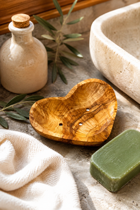 Heart-shaped olive wood soap dish with drainage holes
