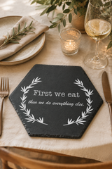 Hexagonal slate Placemat with engraved text on a table setting with plates, glasses, and cutlery.