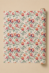 A roll of wrapping paper with a Holly & Bauble Christmas Watercolour paten, partially unrolled to show the repeating print on a solid beige background.