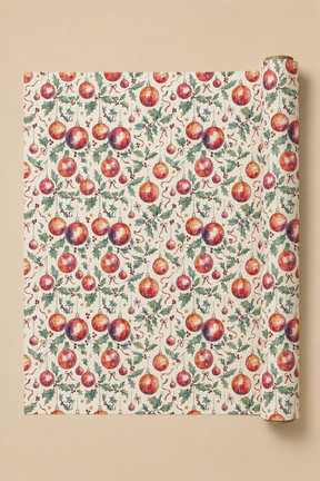 A roll of wrapping paper with a Holly & Bauble Christmas Watercolour paten, partially unrolled to show the repeating print on a solid beige background.