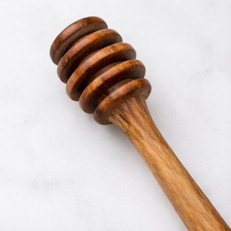 Collage of wooden honey dipper in various settings with honey.