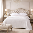  a bedroom with a bed, nightstands, and decor.