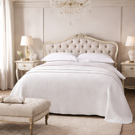  a bedroom with a bed, nightstands, and decor.