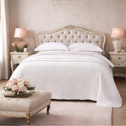  a bedroom with a bed, nightstands, and decor.