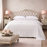  a bedroom with a bed, nightstands, and decor.