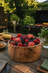 Large Natural Wood Salad & Serving Bowl – 25cm filled with fresh berries and peaches on a rustic outdoor patio table, with a grill and greenery in the background.