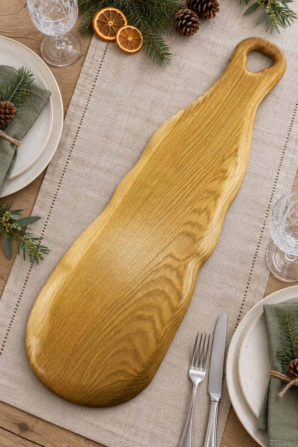 “Large handmade oak charcuterie board with a natural waney edge and detailed wooden handle.”