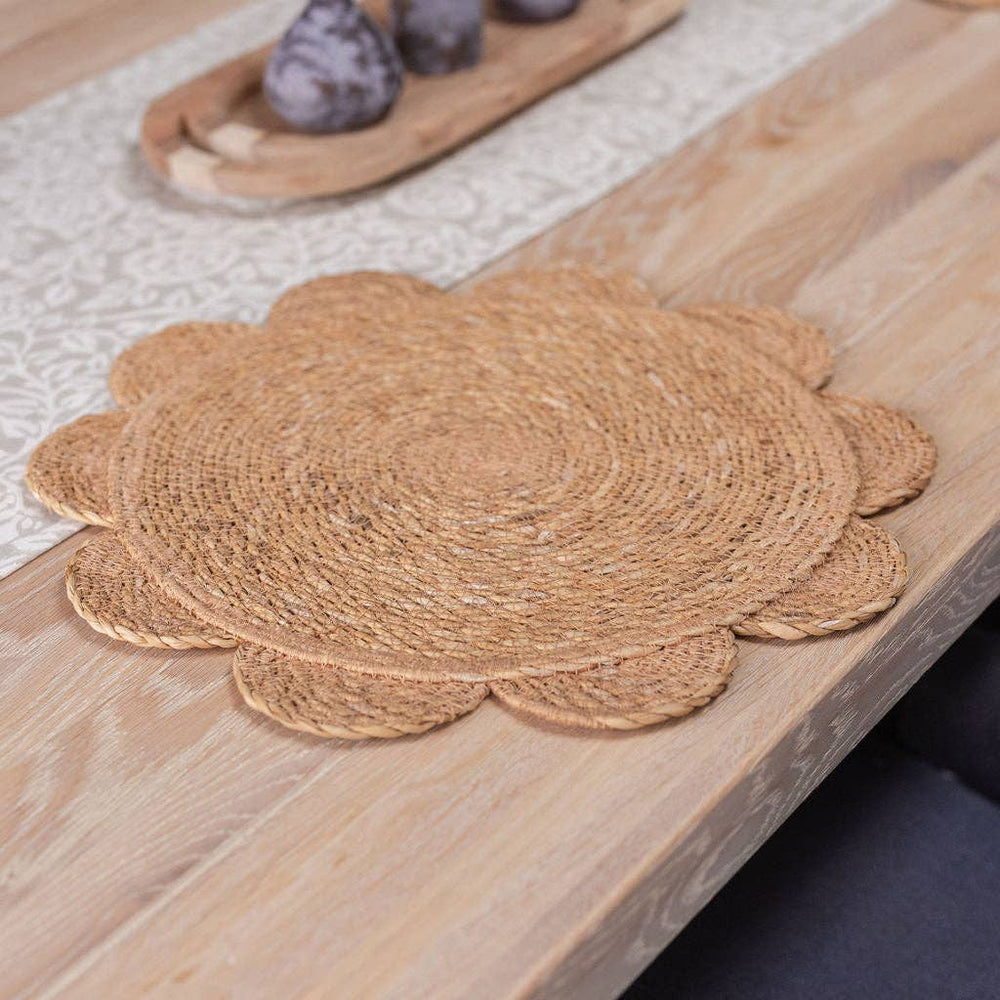 Set of four large natural handwoven seagrass placemats with round scalloped edges, each approximately 40cm in diameter.