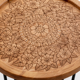 Wooden table with intricate patterns and black hairpin legs, shown from different angles.