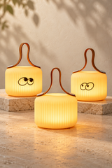 Mochi Pure, Wonder and Peek lamps displayed together on a cream surface with neutral stone display blocks.