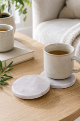 marble coasters on a wooden table, with a  indoor setting.