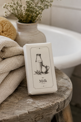 Natural style milk soap bar paired with olive wood soap dish