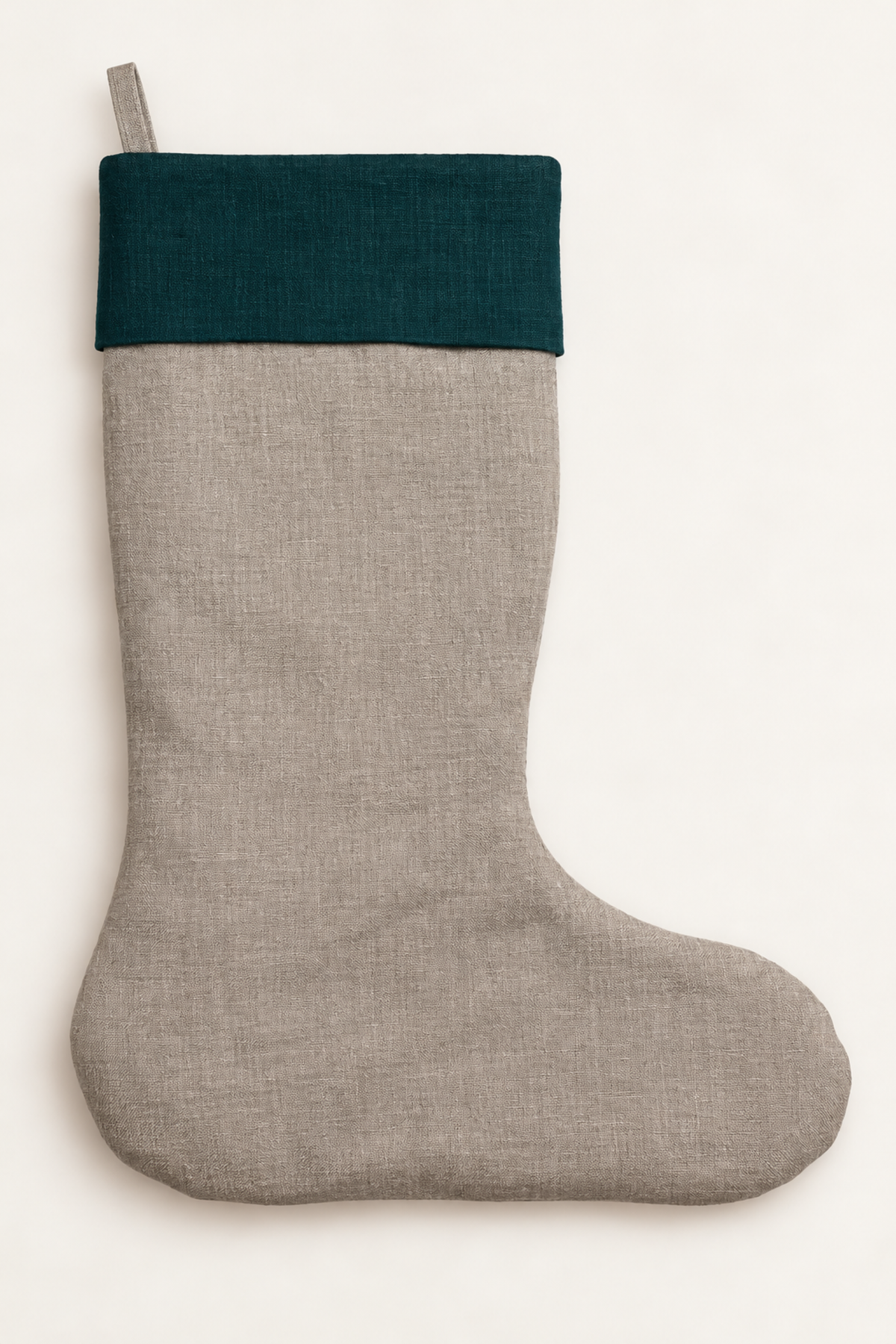 A natural linen Christmas stocking with a dark forest green linen fabric cuff, shown against a plain off-white background.